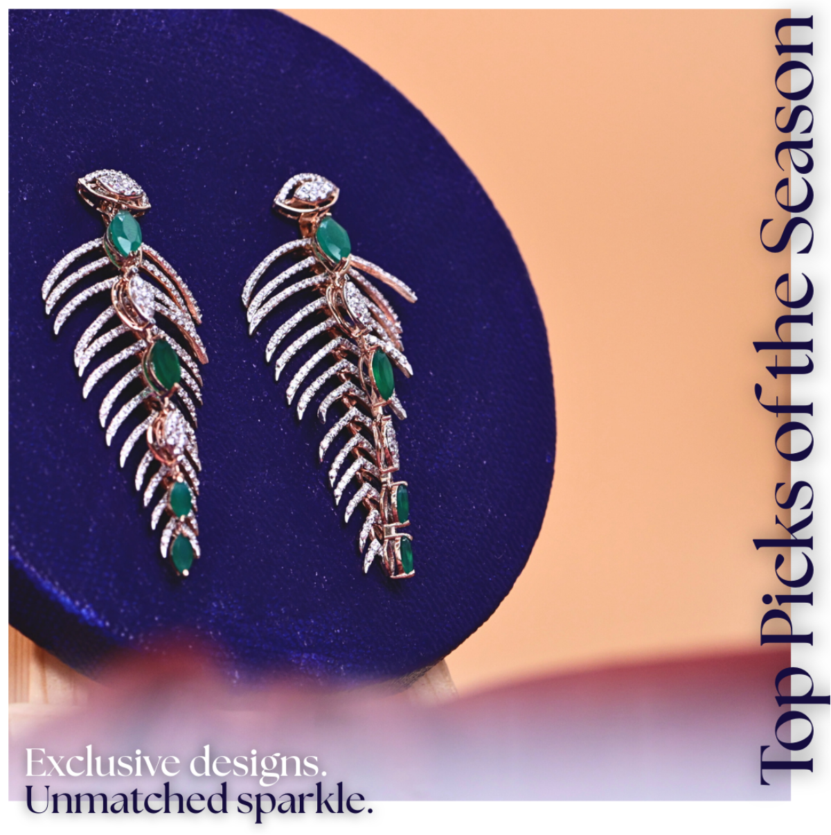 Pair of silver earrings with green gemstones on a blue cushion, with text 'Top Picks of the Season' and 'Exclusive designs. Unmatched sparkle.