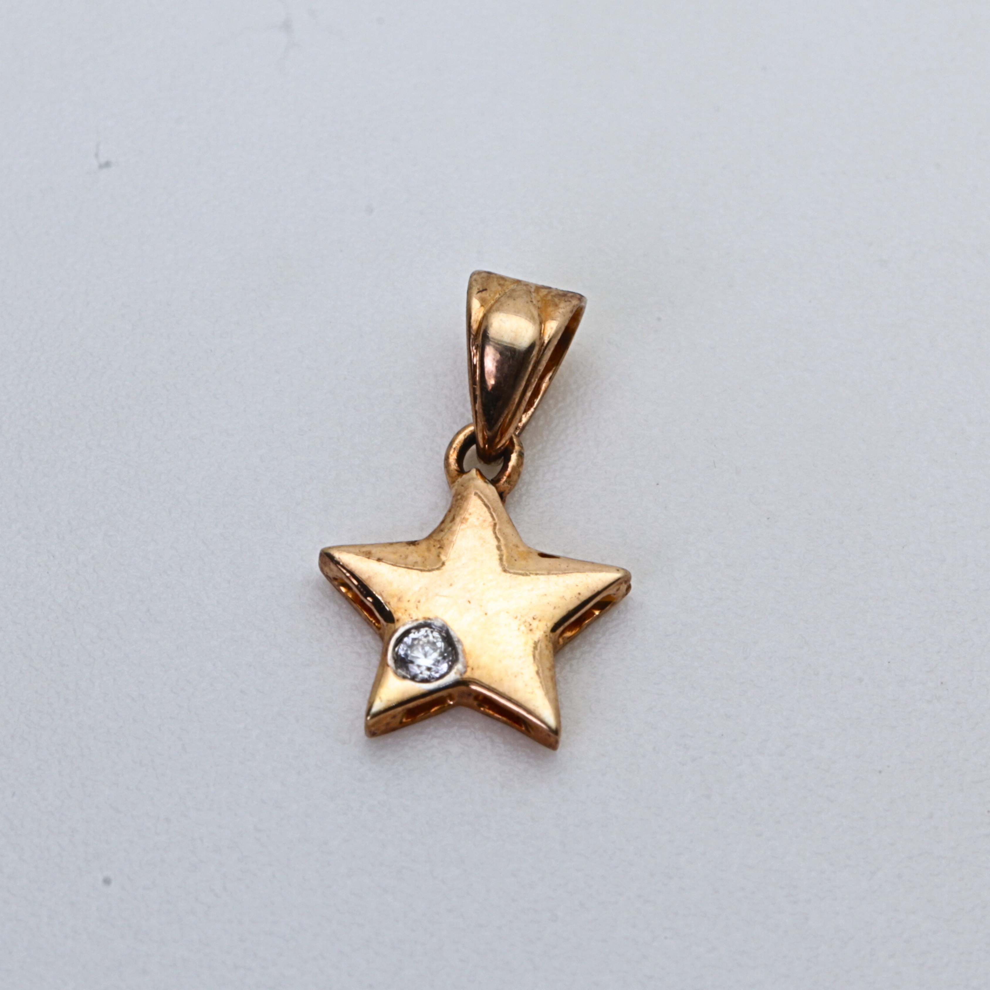 Star Shape Gold Pendant with Single Round Stone Accent