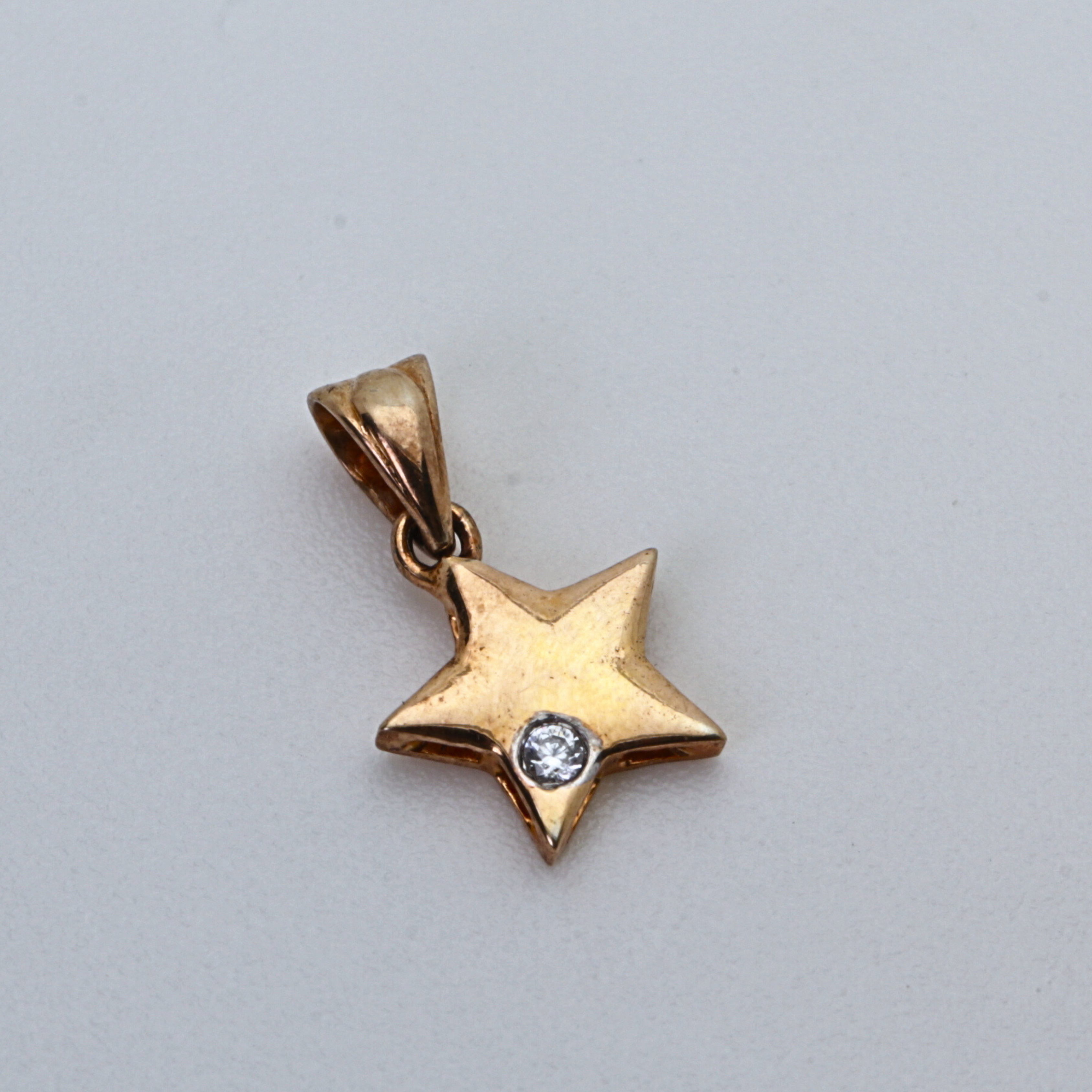 Star Shape Gold Pendant with Single Round Stone Accent