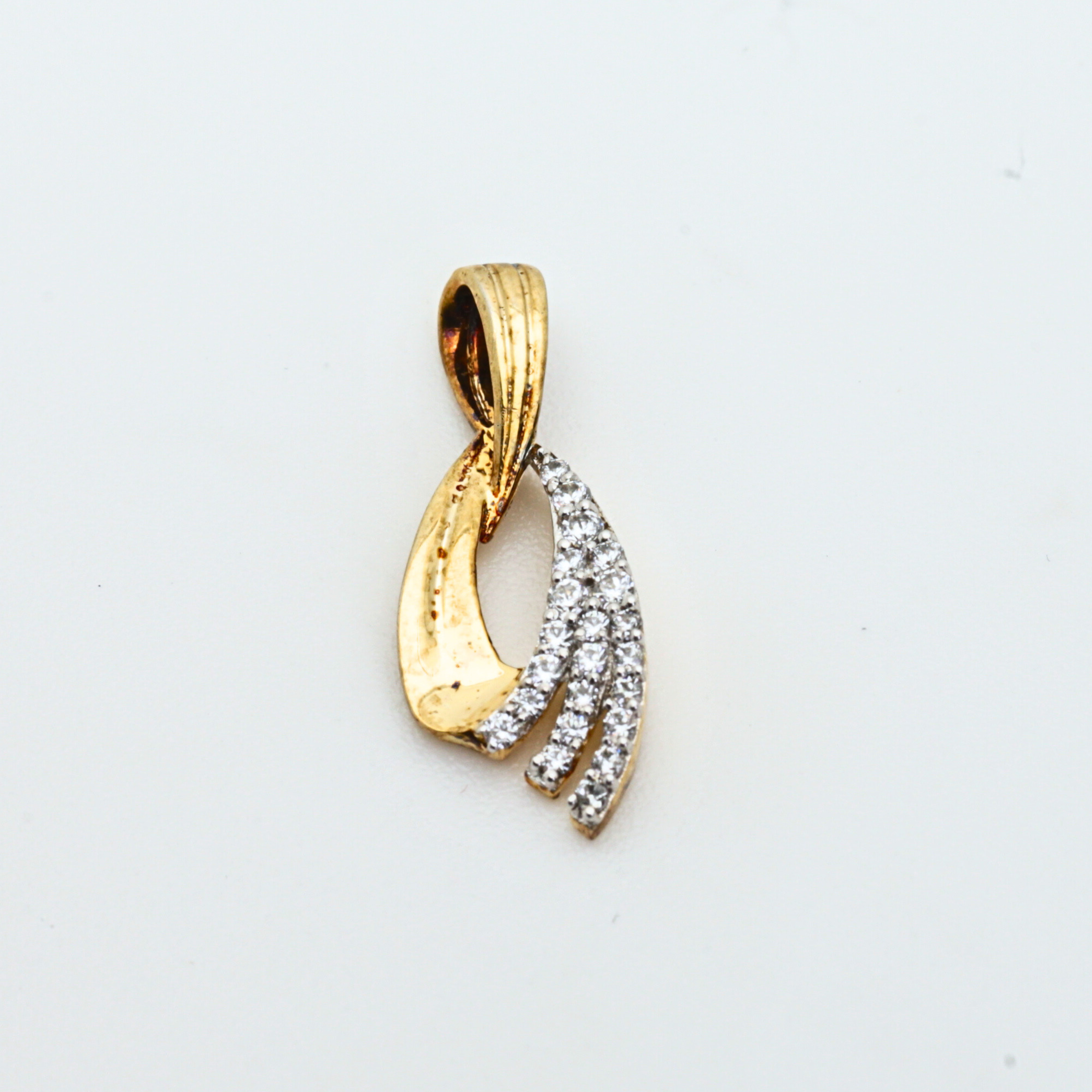 Gold Pendant With Flowing Curve Design And Stone Detailing