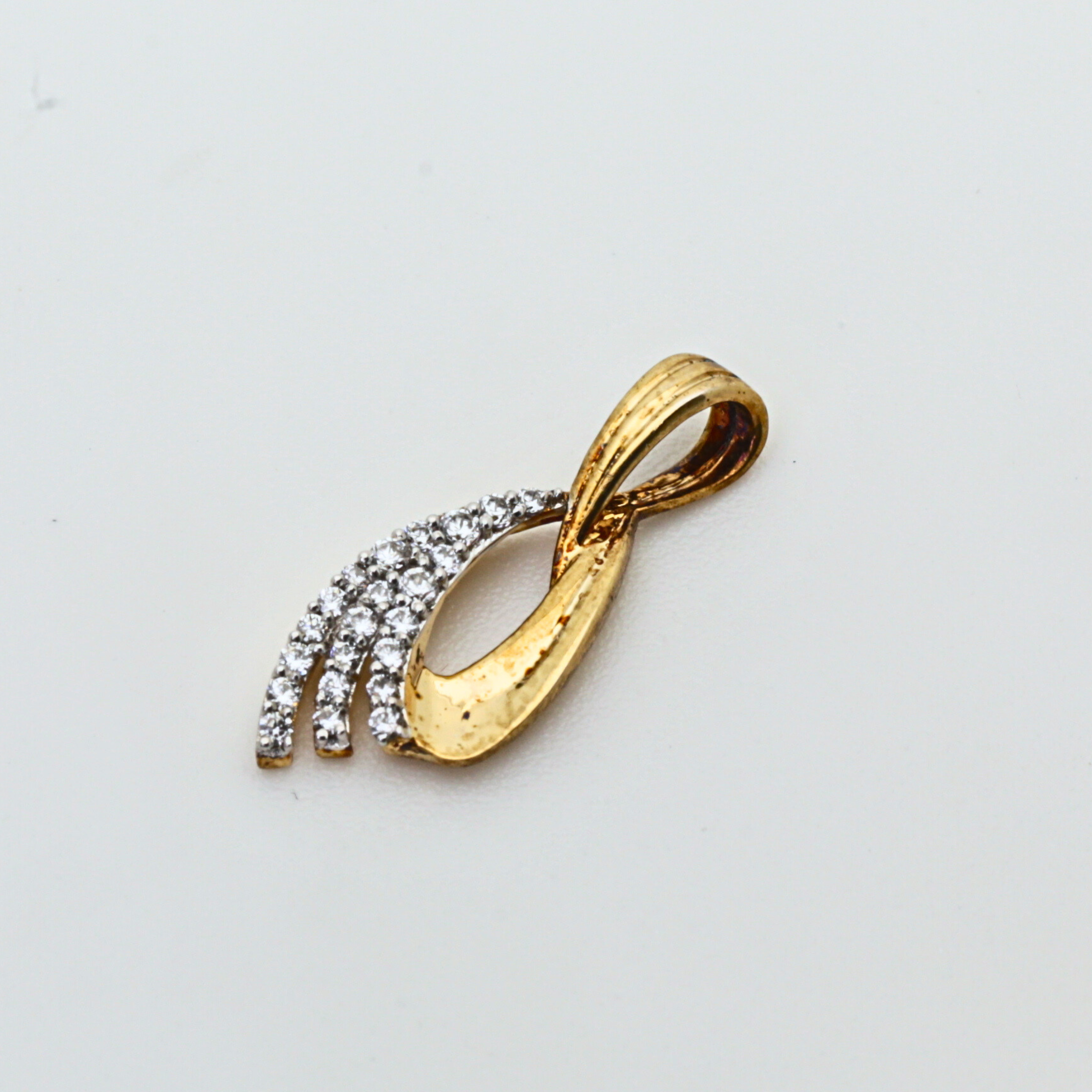 Gold Pendant With Flowing Curve Design And Stone Detailing