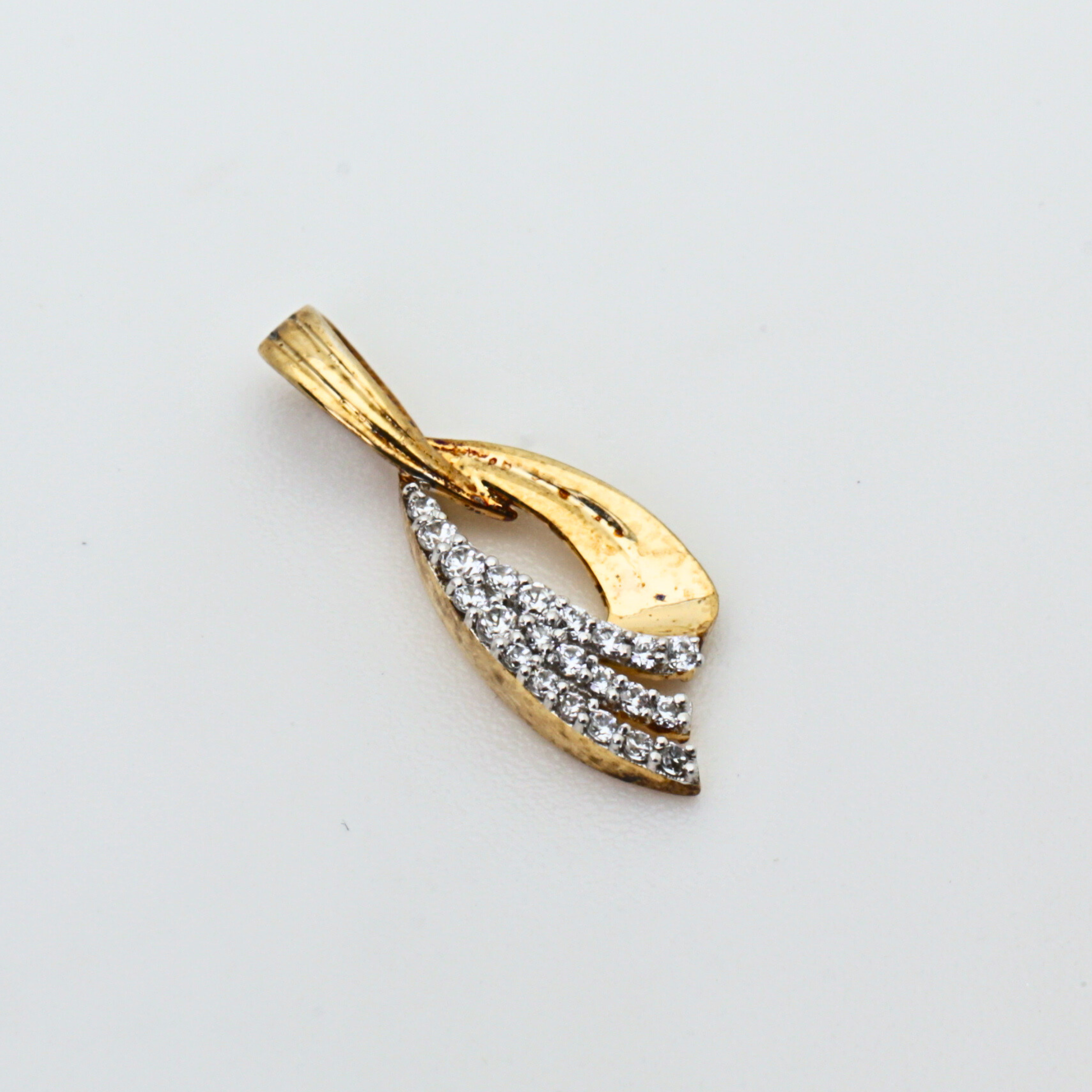 Gold Pendant With Flowing Curve Design And Stone Detailing