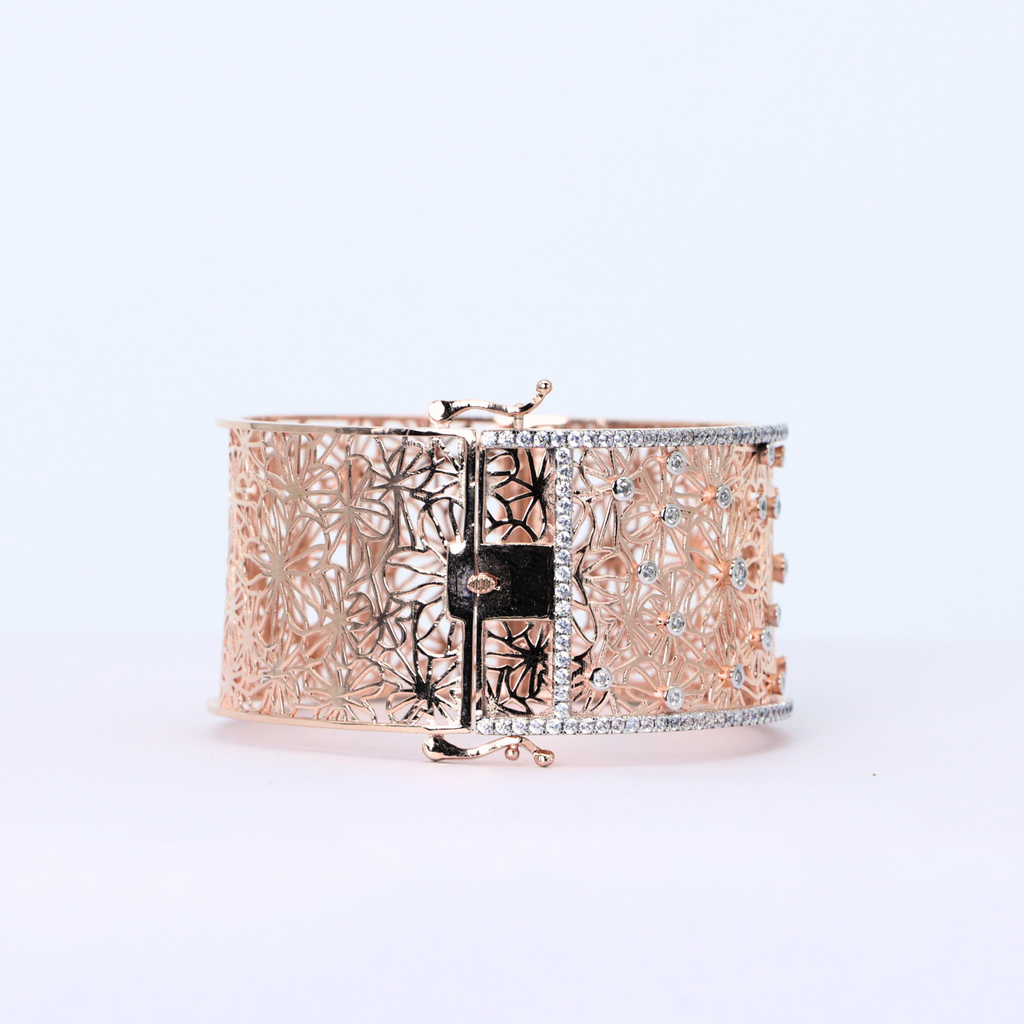Center diamond floral design
Gold band with diamonds
Diamond facets reflecting light
Modern geometric lace cuff
Radiant cut diamond bangle
Diamond bangle with lace pattern
Lace cuff band detail
Close up of halo diamonds
White gold band with diamonds
Shimmering floral cuff bangle