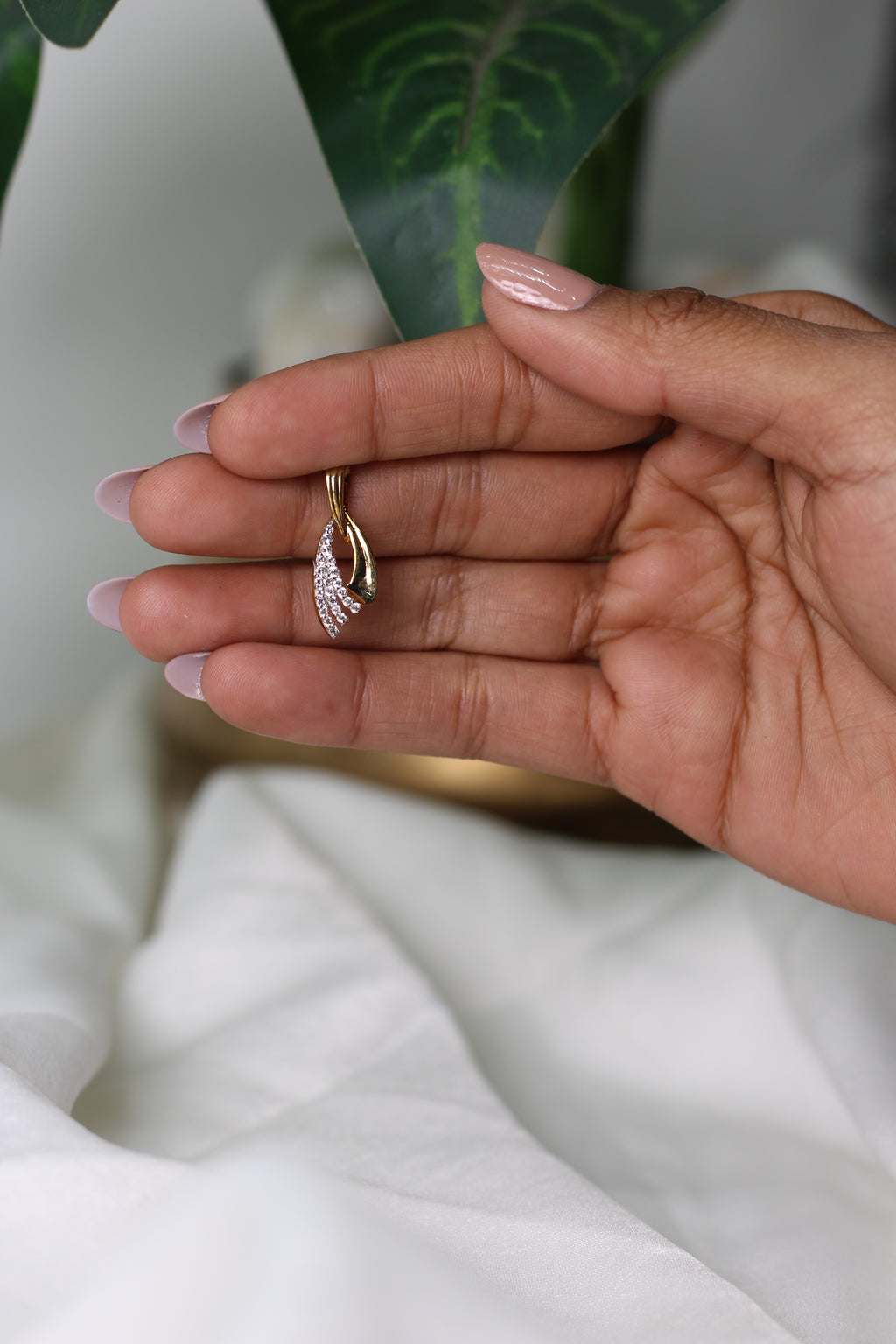 Gold Pendant With Flowing Curve Design And Stone Detailing