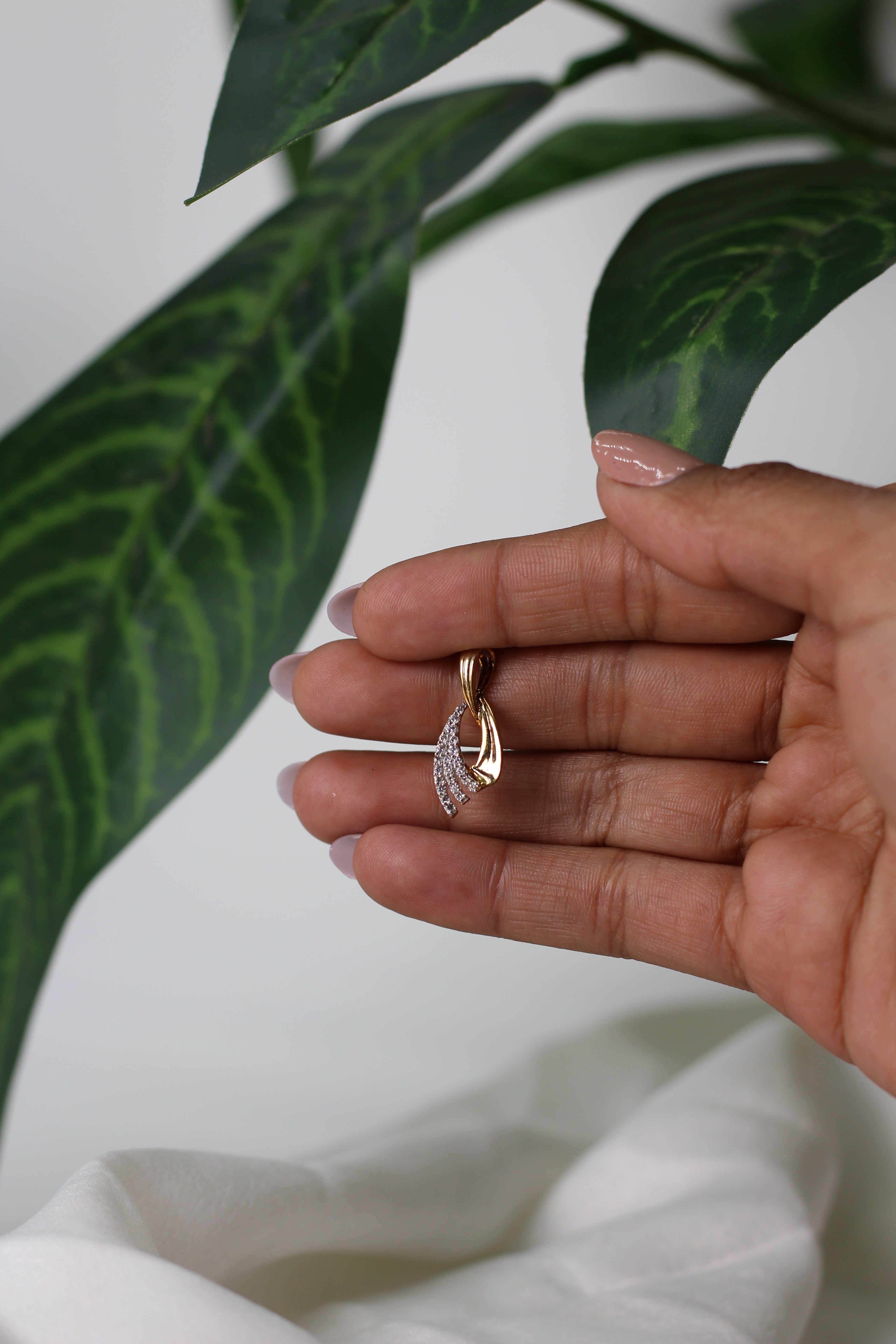 Gold Pendant With Flowing Curve Design And Stone Detailing