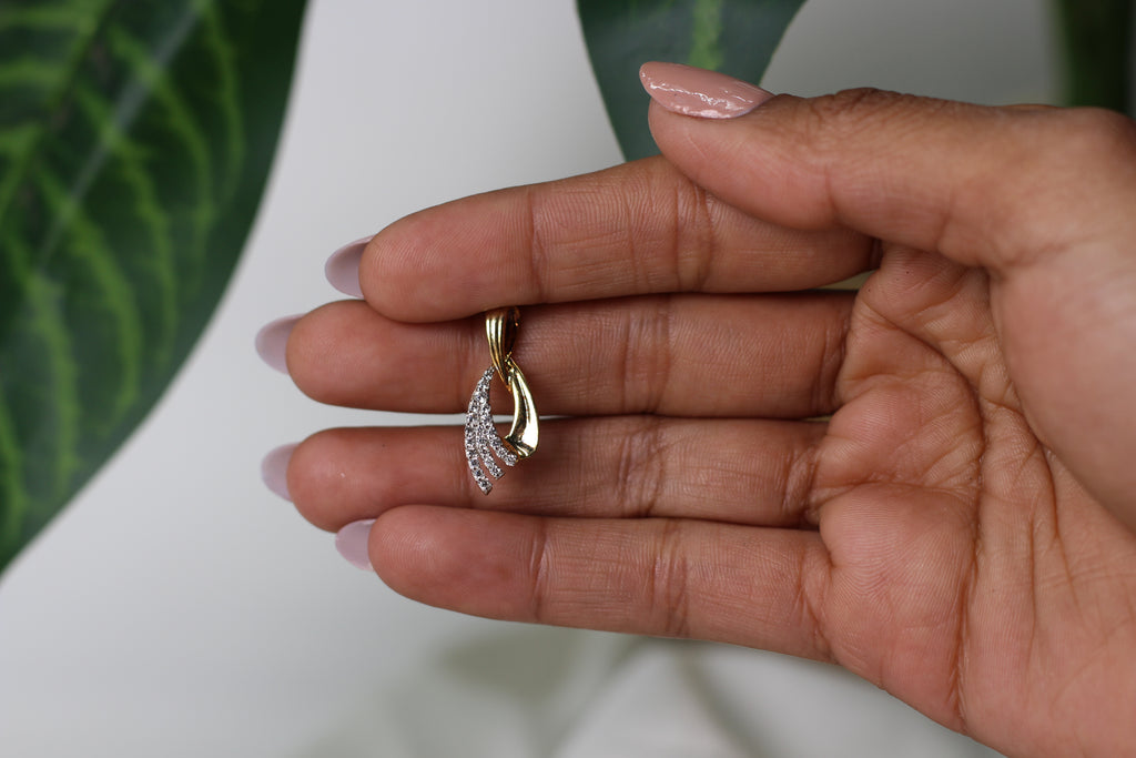 Gold Pendant With Flowing Curve Design And Stone Detailing