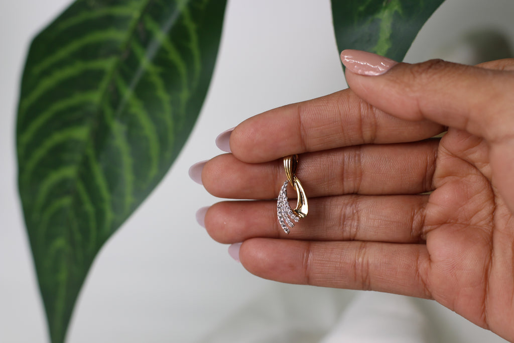 Gold Pendant With Flowing Curve Design And Stone Detailing