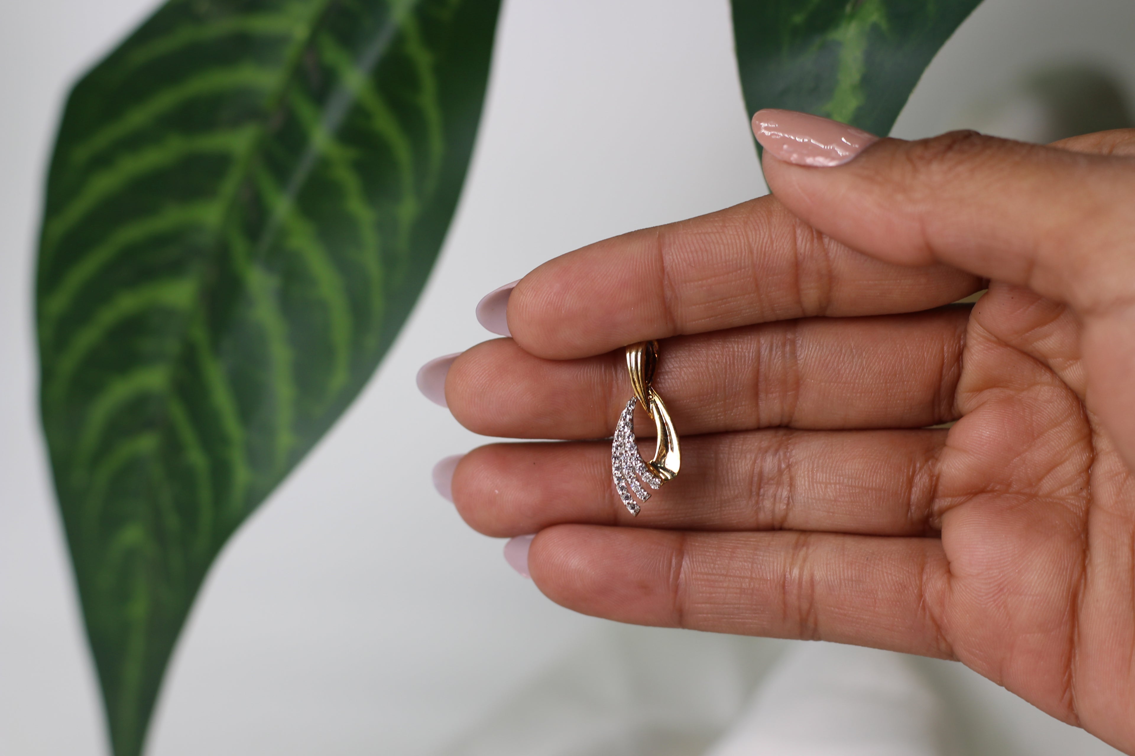 Gold Pendant With Flowing Curve Design And Stone Detailing